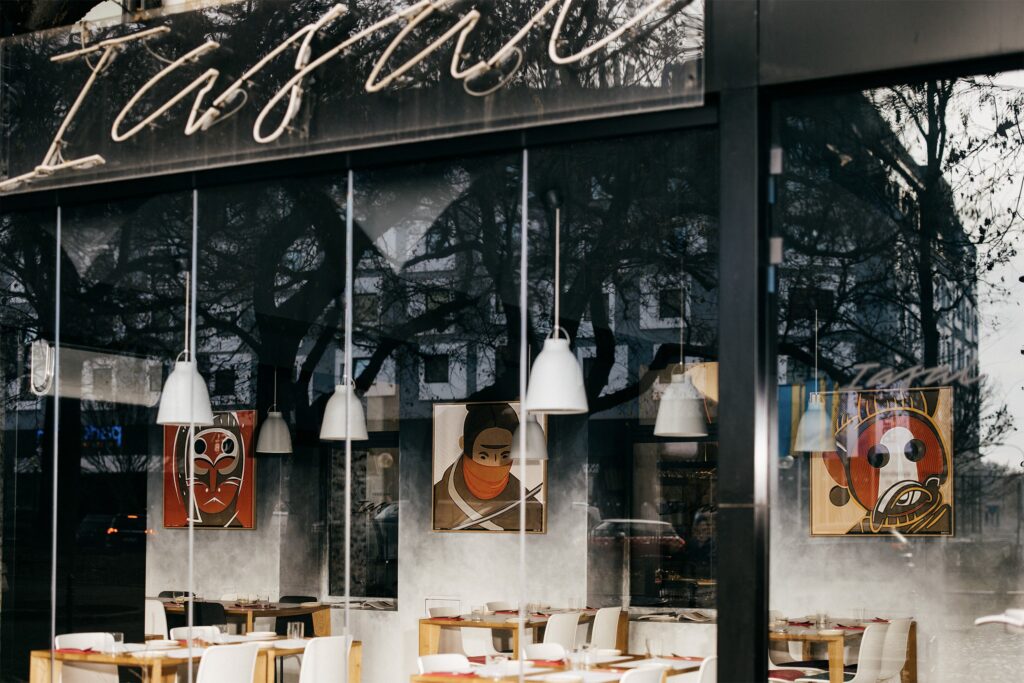 Kanji by Zolo Kis — framed artworks displayed along a restaurant window