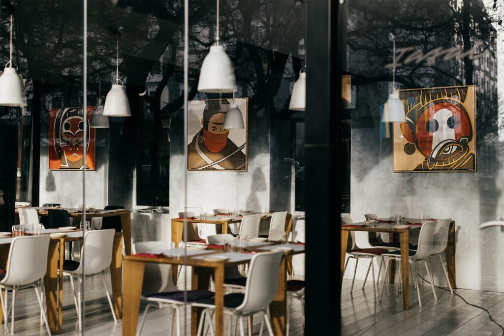 Hariko by Zolo Kis — framed artworks displayed in a sunlit restaurant window