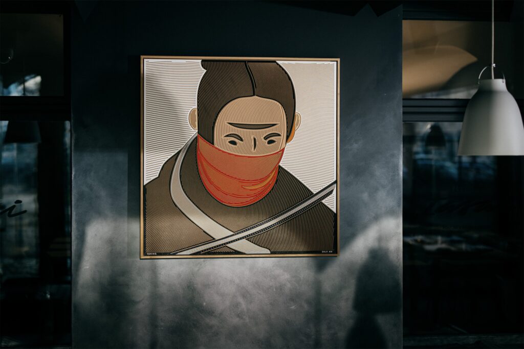 Hariko by Zolo Kis — the warrior portrait displayed on a dark restaurant wall