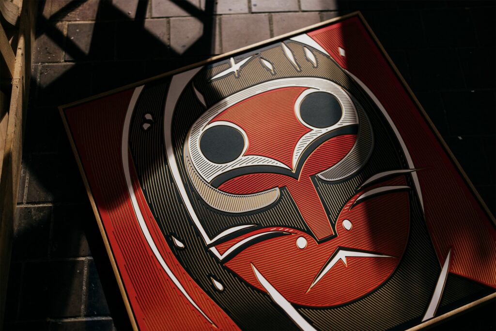 Kanji by Zolo Kis — angled view of the framed masked portrait resting on a chair