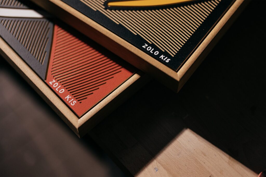 Kanji by Zolo Kis — close-up of stacked wooden frames and red and dark milled panels