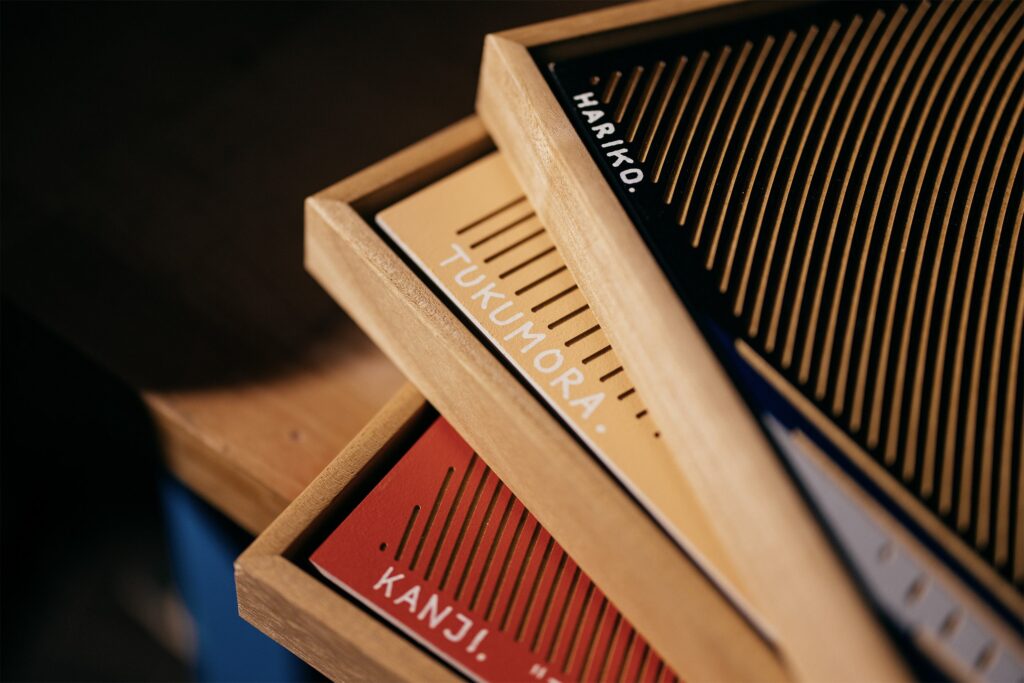 Hariko by Zolo Kis — stacked wooden frames with coloured relief panels and signatures
