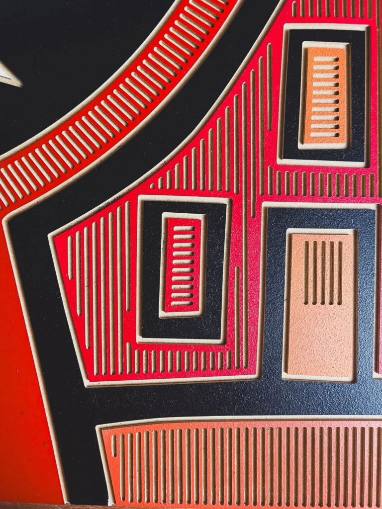 Butt Boy by Zolo Kis — close-up of red, black and pale rectangular patterns beside the face