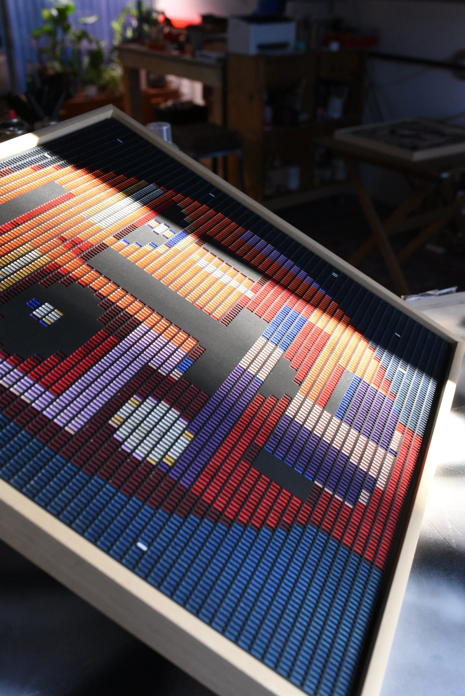 Starboy edition S by Zolo Kis — framed face in orange, purple and blue, lying in sunlight in the studio