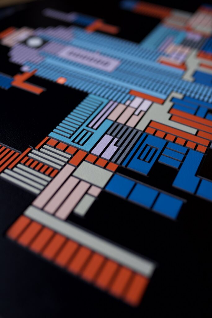 Zolo Kis artwork — low-angle view of blue and orange milled shapes with shallow depth of field