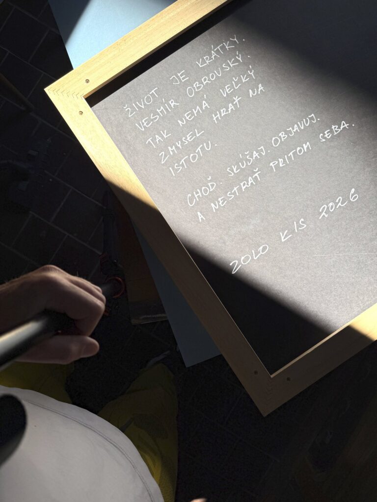 Zolo Kis artwork — back of the framed panel with a handwritten inscription in sunlight