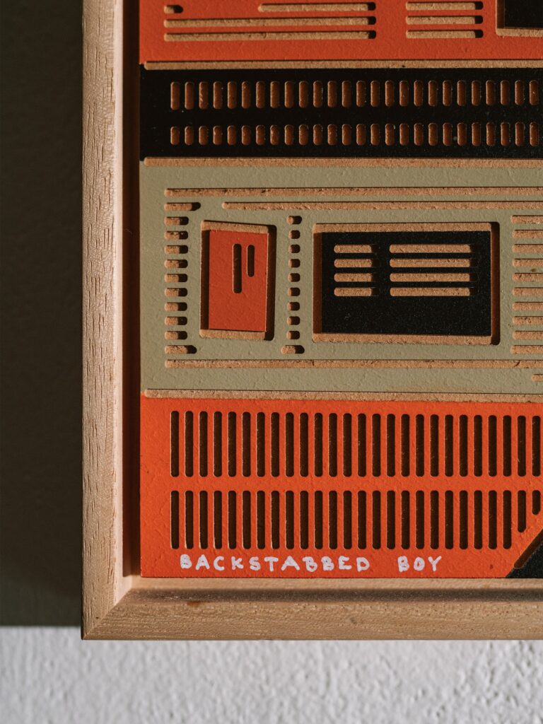 Backstabbed Boy by Zolo Kis — close-up of rectangular relief patterns and the Backstabbed Boy title