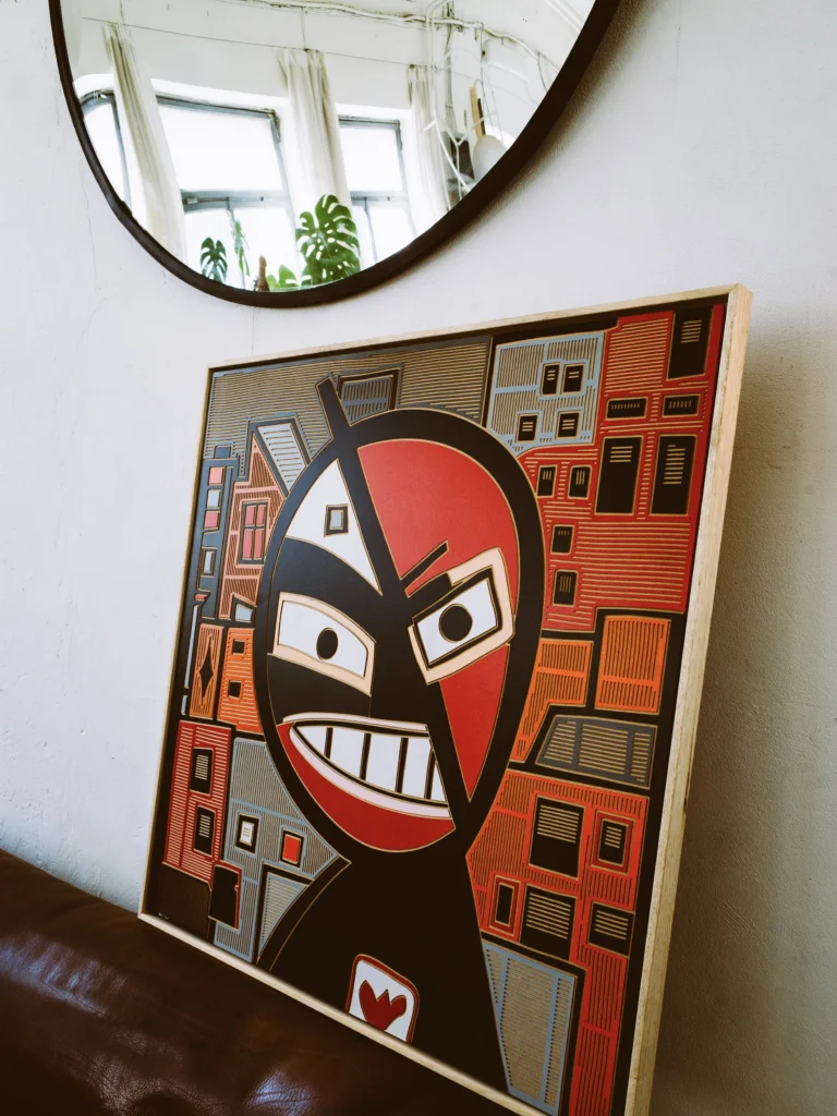 Bad Boy by Zolo Kis — the framed grinning portrait leaning beneath a round mirror