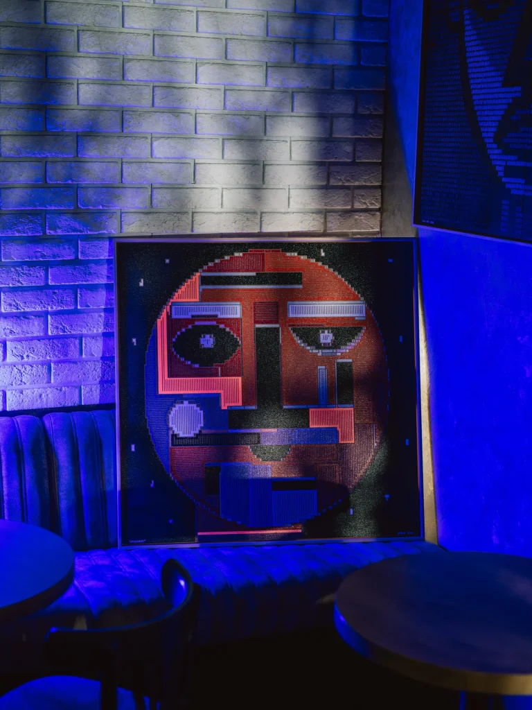 Starboy by Zolo Kis — the framed portrait displayed against a brick wall in blue light
