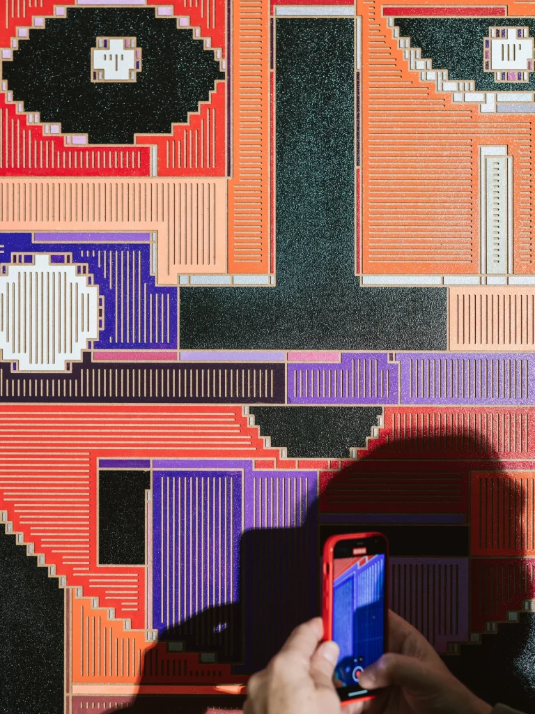 Starboy by Zolo Kis — a phone photographing a close-up of the colourful relief face