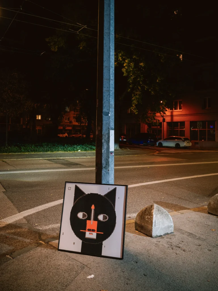 The Cat - Tokio by Zolo Kis — the framed cat portrait standing beside a streetlamp at night